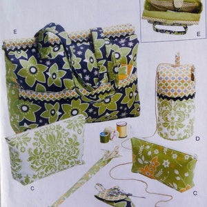 May include: A set of green and black fabric bags, pouches, and accessories. The set includes a large tote bag, a smaller pouch, a pencil case, a needle case, and a small zippered pouch. The fabric is patterned with green flowers and leaves on a black background.