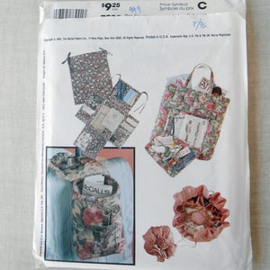 May include: A sewing pattern for making various bags and pouches. The pattern includes instructions for a large tote bag, a smaller pouch, and a drawstring bag. The bags are all decorated with floral patterns.