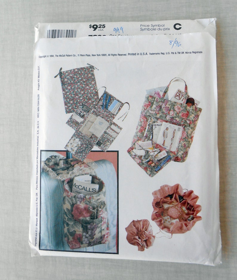 May include: A sewing pattern for making various bags and pouches. The pattern includes instructions for a large tote bag, a smaller pouch, and a drawstring bag. The bags are all decorated with floral patterns.