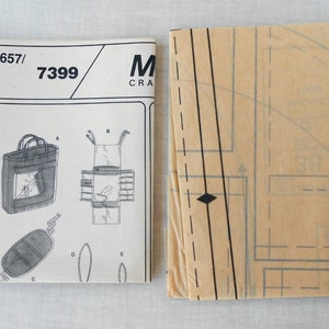 May include: A sewing pattern for a tote bag with a zippered pocket. The pattern is labeled "657/7399" and is from McCall's Crafts.