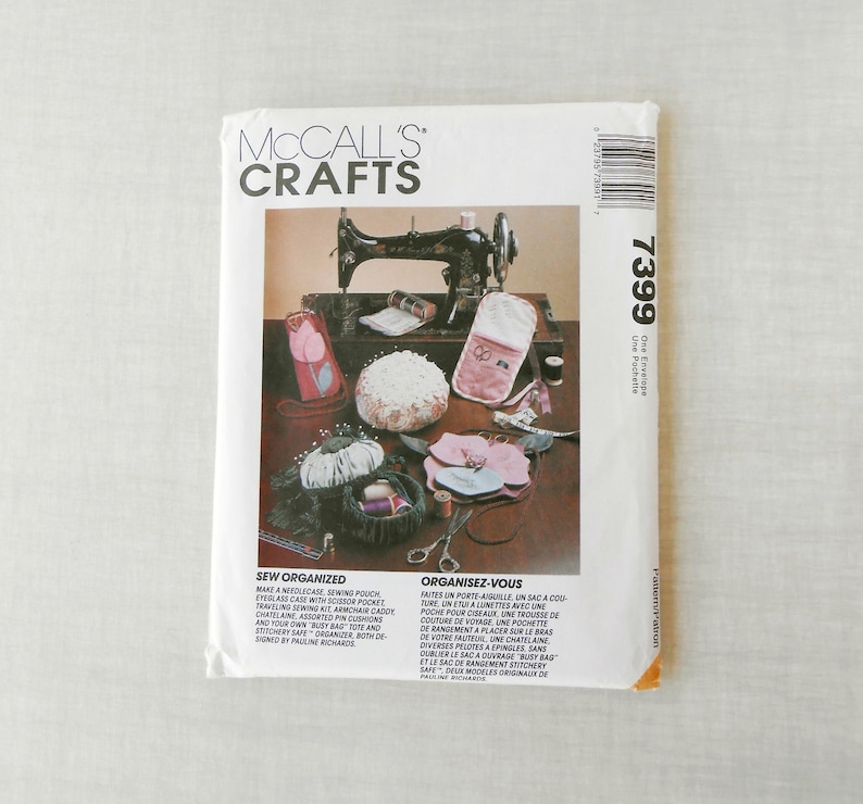May include: A vintage sewing pattern package for a needle case, eyeglass case, pin cushions, and a tote bag. The pattern is from McCall's Crafts and is titled "Sew Organized" and "Organisez-Vous".