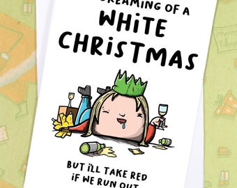 May include: A white Christmas card with the text "I'M DREAMING OF A WHITE CHRISTMAS" and "BUT I'LL TAKE RED IF WE RUN OUT". The illustration shows a cartoon character wearing a green crown, surrounded by wine bottles and glasses.