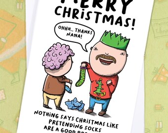 May include: A Christmas greeting card with a cartoon illustration. The card reads "MERRY CHRISTMAS!" and features two characters, one holding a Christmas stocking. The text bubble says "OHHH.. THANKS NANA!". The bottom of the card reads "NOTHING SAYS CHRISTMAS LIKE PRETENDING SOCKS ARE A GOOD PRESENT.."