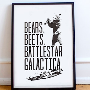 May include: Black and white print of a bear standing on its hind legs with the text "Bears. Beets. Battlestar Galactica."  The image also includes a silhouette of a spaceship.