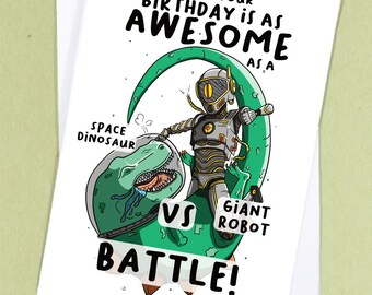 May include: A birthday card featuring a green space dinosaur battling a giant robot. The card reads "I hope your birthday is as awesome as a space dinosaur vs giant robot battle!"