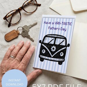 May include: A Father's Day card featuring a black and white van illustration with the text "Have a VAN-TASTIC Fathers Day." The card is open, showing a blank interior. Eyeglasses, keys, and a keychain are also visible.