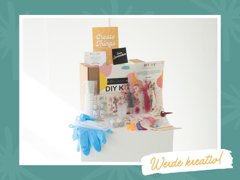 May include: A craft kit containing bottles, gloves, and decorative items. The box is labelled "DIY KIT" and a sign reads "Create Things". The image also includes the text "Werde kreativ!"