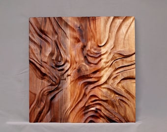 May include: A wooden wall art piece with a carved, abstract design. The wood is a rich brown color with a reddish hue. The design is reminiscent of flowing water or waves.