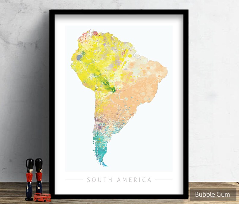 May include: A watercolor print of South America with a yellow, orange, and blue color scheme. The print is framed in a black frame and has the text "SOUTH AMERICA" at the bottom.