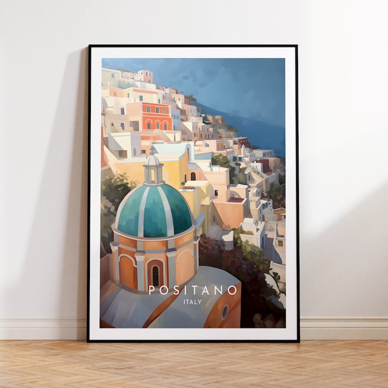 May include: A colorful painting of the town of Positano, Italy. The painting features a large, green-domed church building in the foreground, with a hillside of colorful buildings behind it. The text "Positano, Italy" is printed at the bottom of the painting.