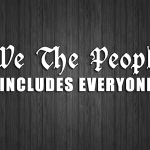 May include: White text on a dark wood background reads "We the People includes everyone".