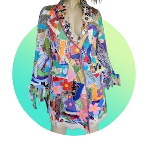 May include: A patchwork jacket with a vibrant mix of colors and patterns. The jacket features a variety of fabric scraps sewn together, including floral and geometric designs. It has a button closure and fringe detailing on the sleeves, with a lace trim at the bottom.