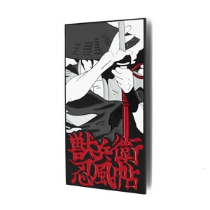 May include: Black and white enamel pin featuring a character from the anime "Demon Slayer" with a red sword and the Japanese text "鬼滅の刃" (Demon Slayer).