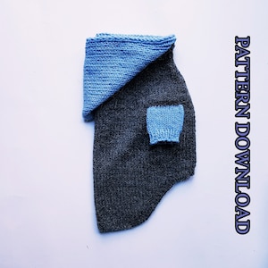 May include: A knitted dog sweater with a blue hood and a blue patch on the front. The sweater is gray and has a fluffy texture. The text "PATTERN DOWNLOAD" is visible on the right side of the image.
