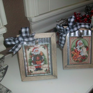 May include: Two rustic wooden picture frames with black and white checkered ribbon bows. Each frame features a vintage Christmas card with a Santa Claus illustration. The text on the card reads "Merry Christmas".