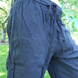 May include: Black cotton pants with a drawstring waist.