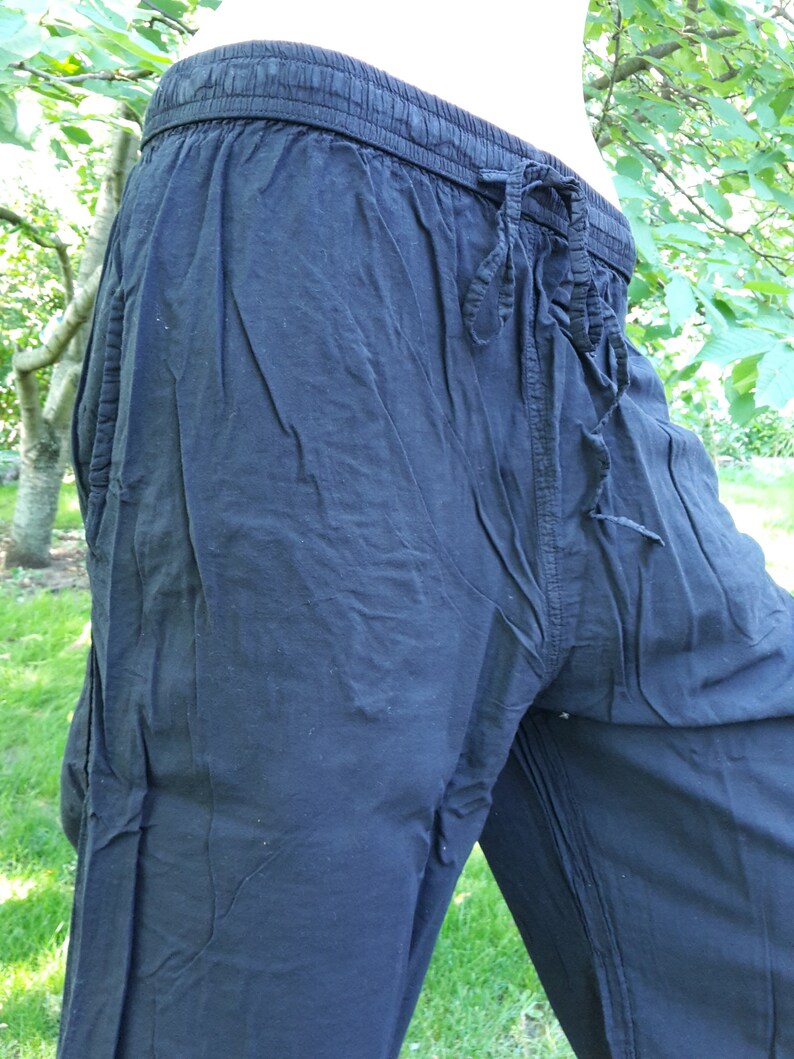 May include: Black cotton pants with a drawstring waist.
