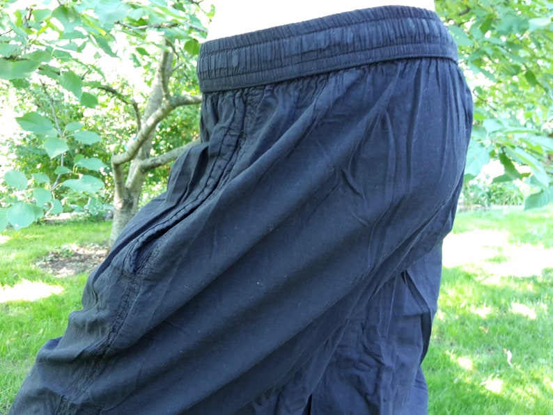 May include: Black cotton pants with a drawstring waistband.