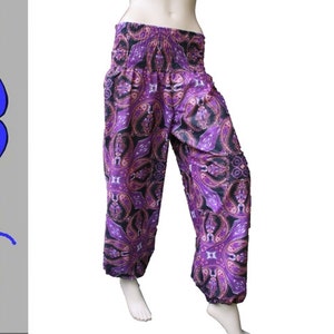 Könnte beinhalten: Lila und schwarze gemusterte Hose mit elastischem Bund. Die Hose hat eine lockere, fließende Passform.