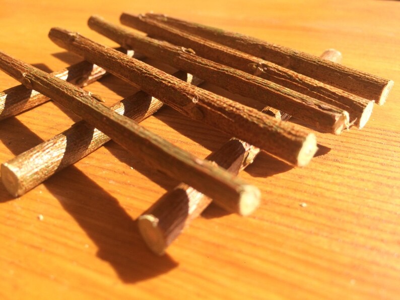 May include: A set of brown wooden sticks arranged in a grid pattern. The sticks are smooth and have a natural finish.