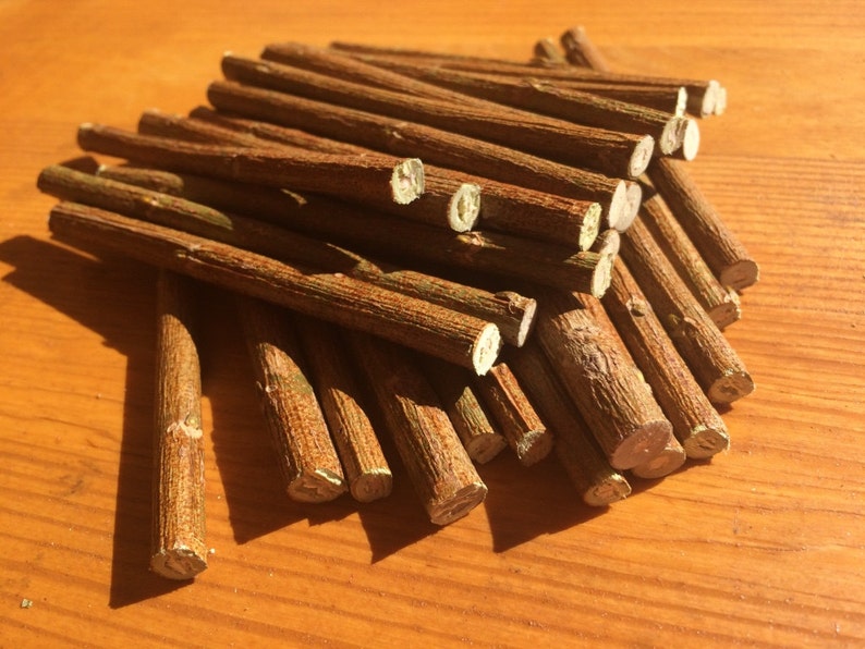 May include: A pile of brown wooden sticks, likely for crafts or model building.