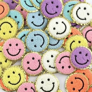May include: Assortment of colorful, fuzzy smiley face patches with gold trim. The patches are perfect for adding a touch of whimsy to clothing, bags, or other accessories.