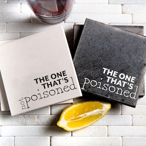 May include: Two square coasters with a white background and black text. The text on the coasters reads "The One That's Poisoned for You".