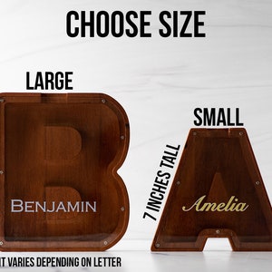 May include: Two wooden letter boxes, one large and one small. The large box is 8-9 inches tall and the small box is 7 inches tall. The large box has the name "Benjamin" written on it and the small box has the name "Amelia" written on it. The boxes are made of wood and have a clear acrylic front.