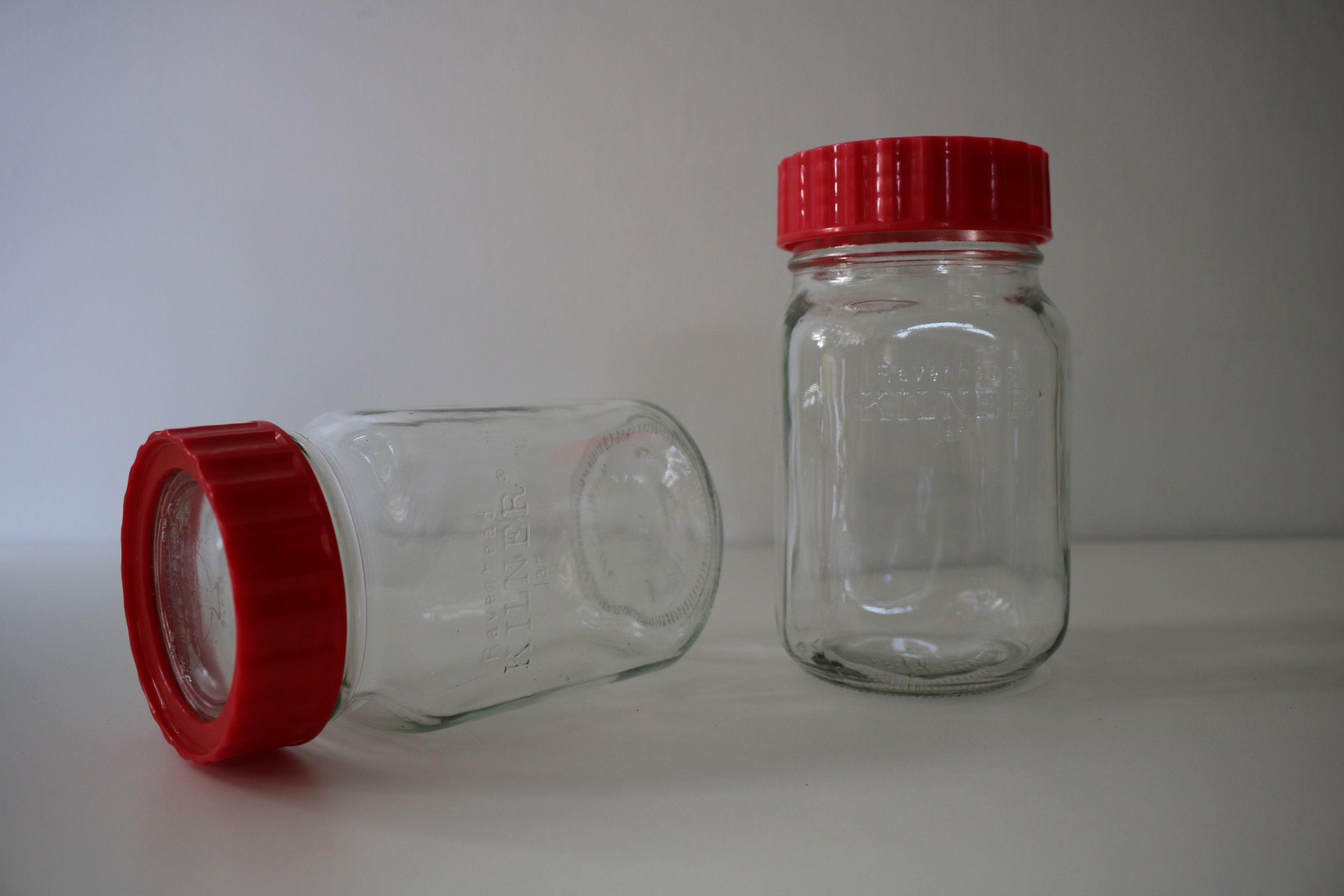 Pair of red Ravenhead Kilner jars 1 litre