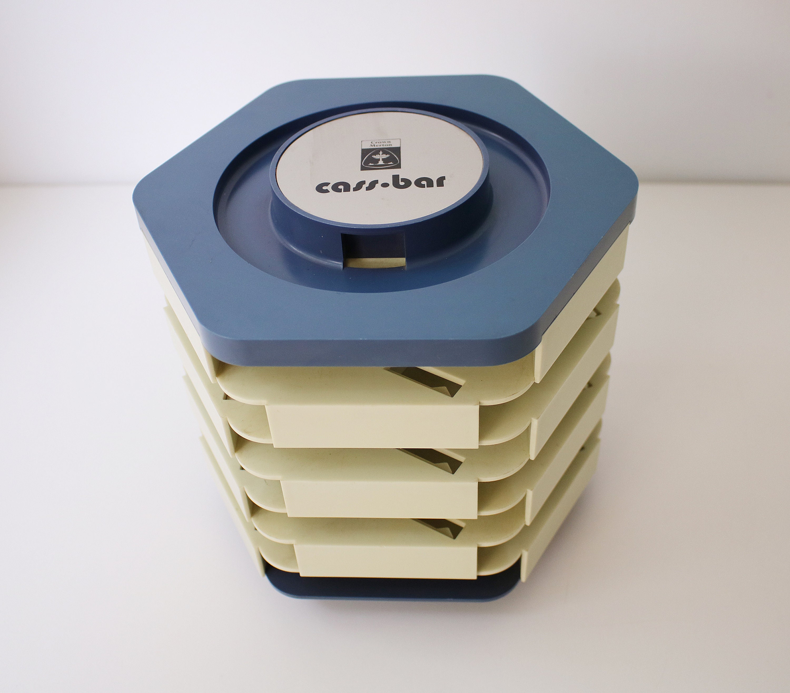 Revolving audio cassette tape storage rack in blue and grey plastic