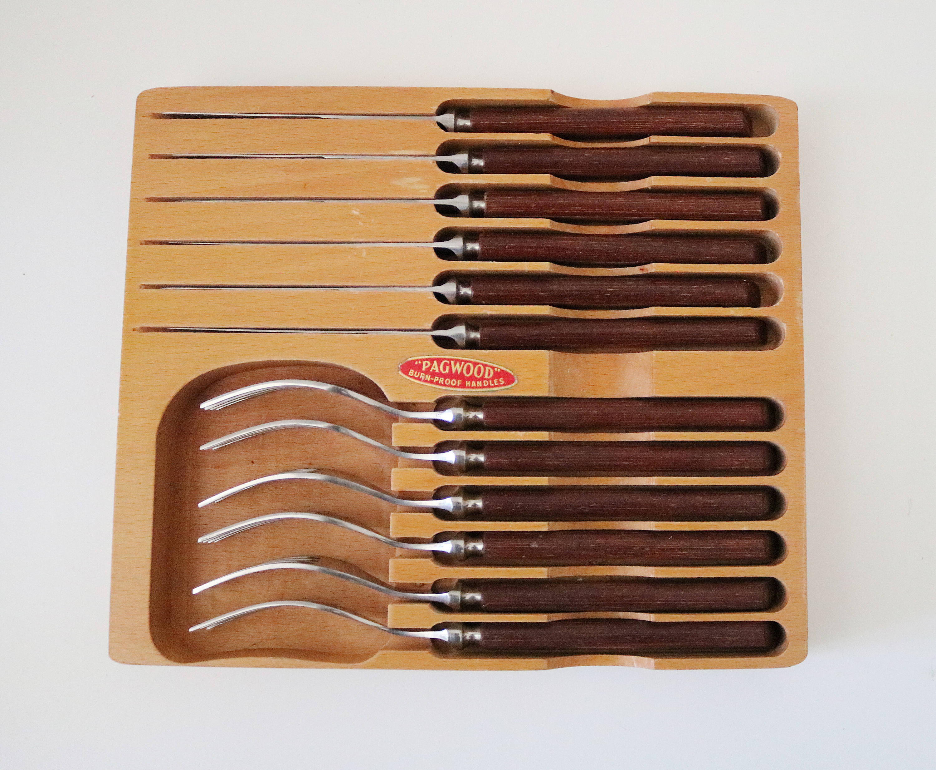 Mid century Pagwood teak and stainless steel steak knife and fork set