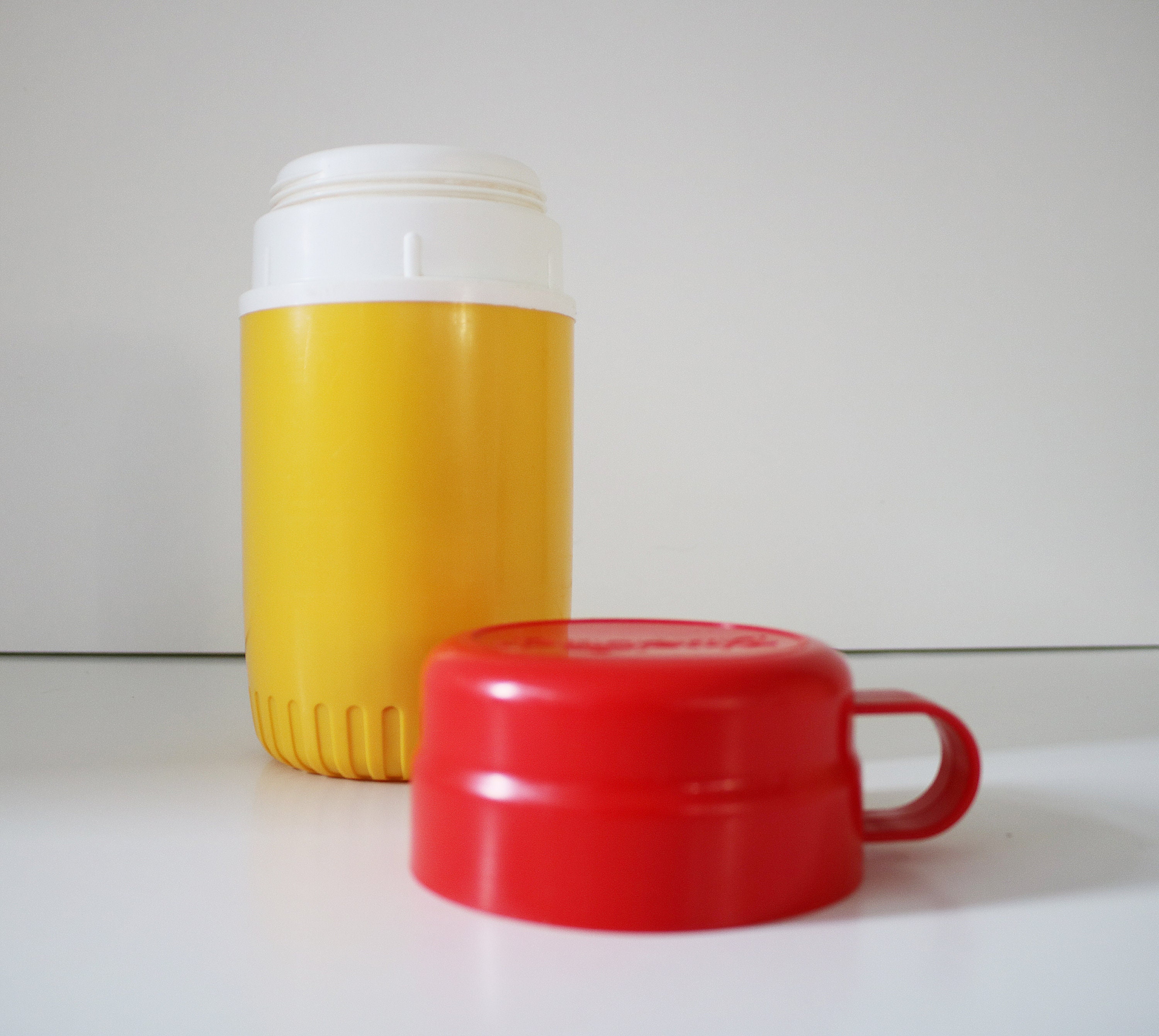 1980s flask by Bluebird Toys in bright yellow and red plastic