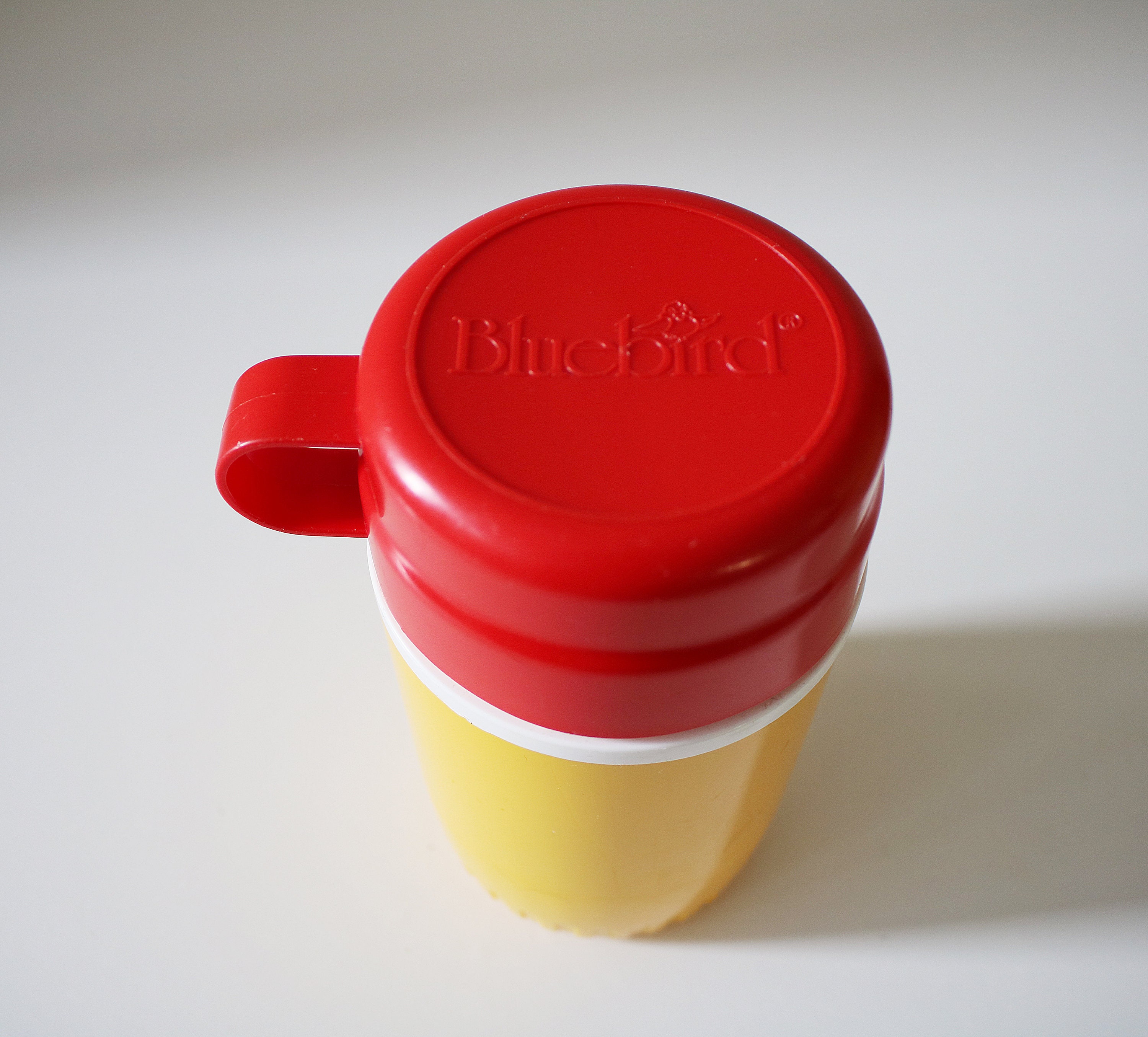 1980s flask by Bluebird Toys in bright yellow and red plastic