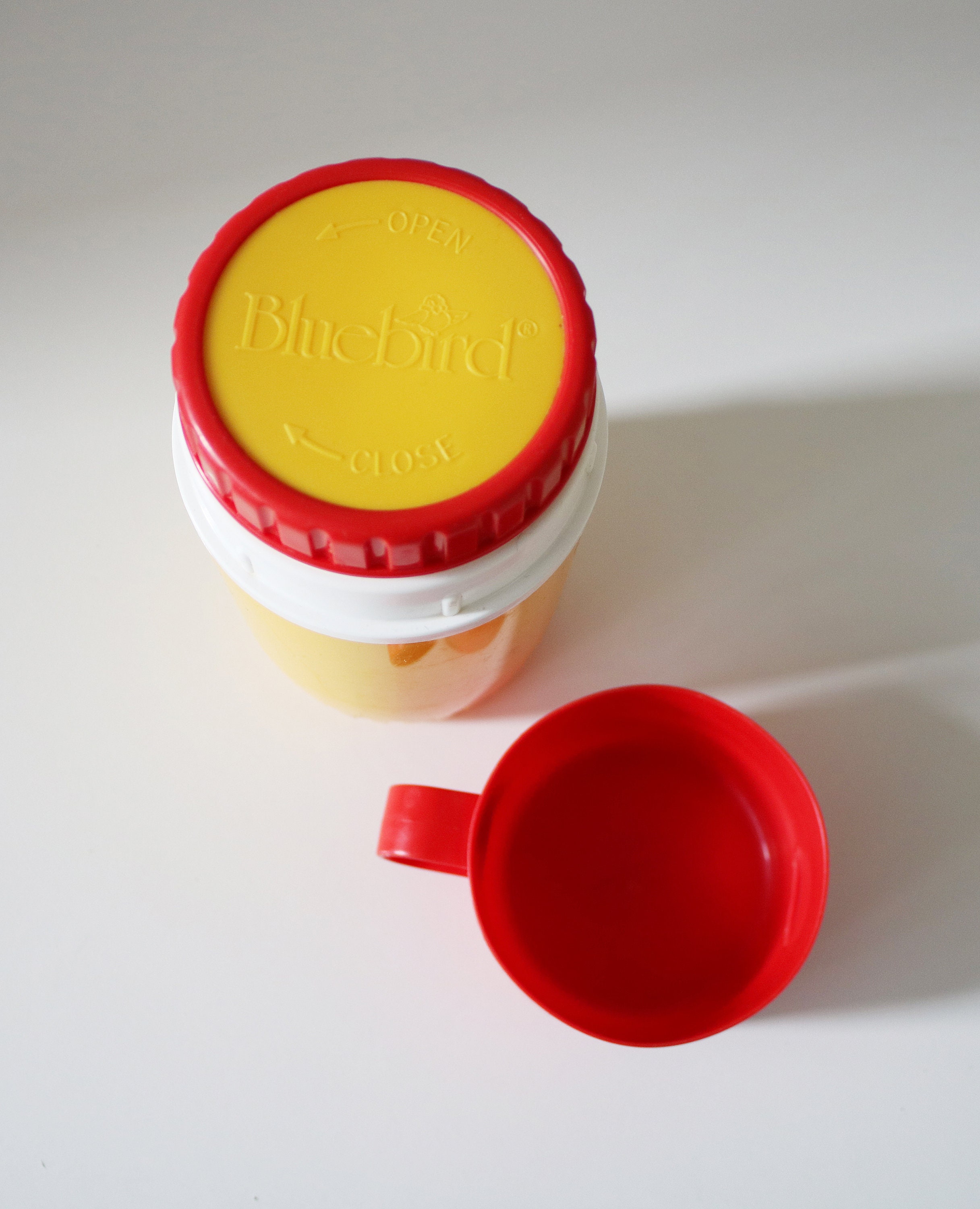 1980s flask by Bluebird Toys in bright yellow and red plastic