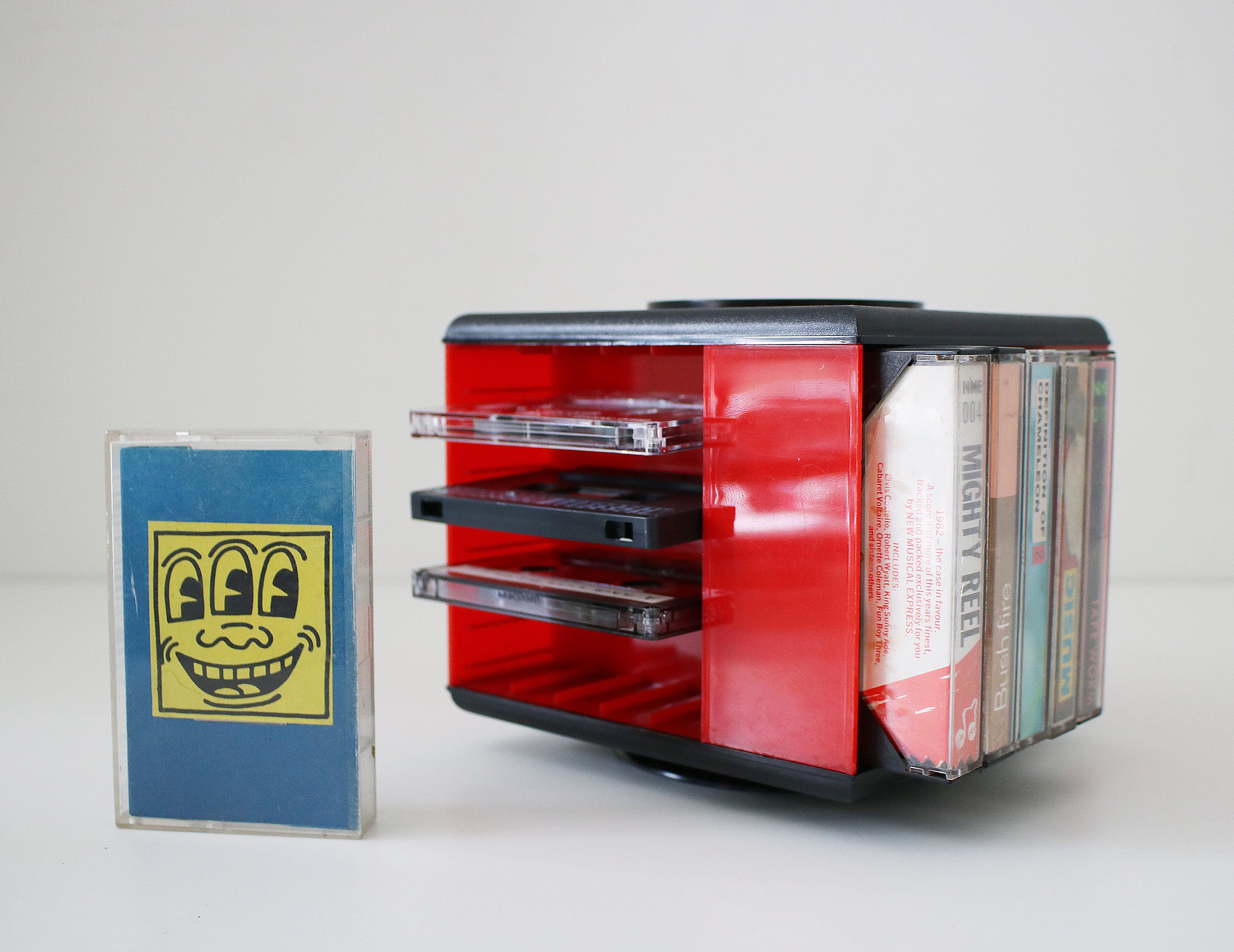 1980s revolving audio cassette tape storage rack in red and black