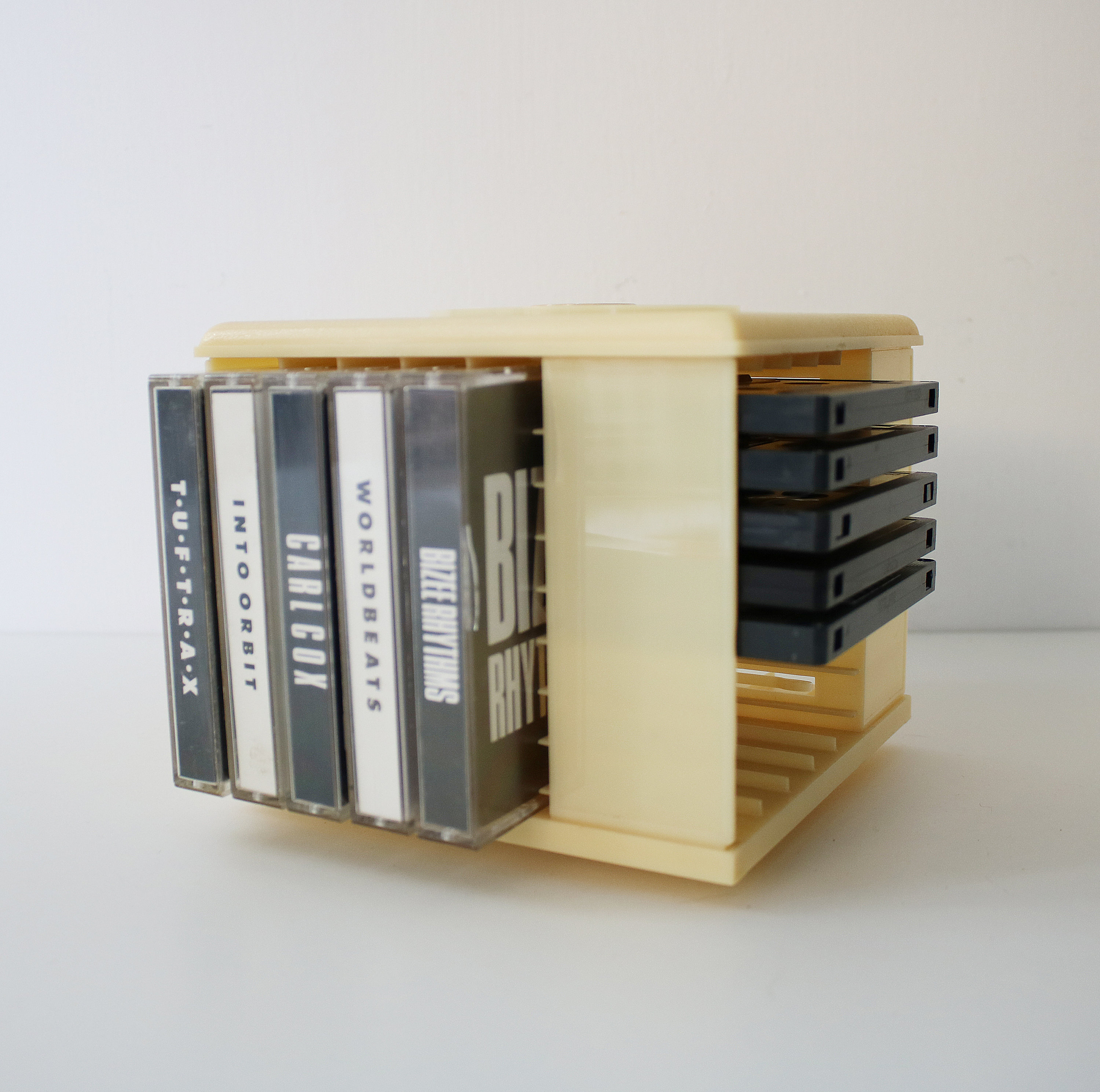 Rotating audio cassette tape storage holder rack in cream plastic