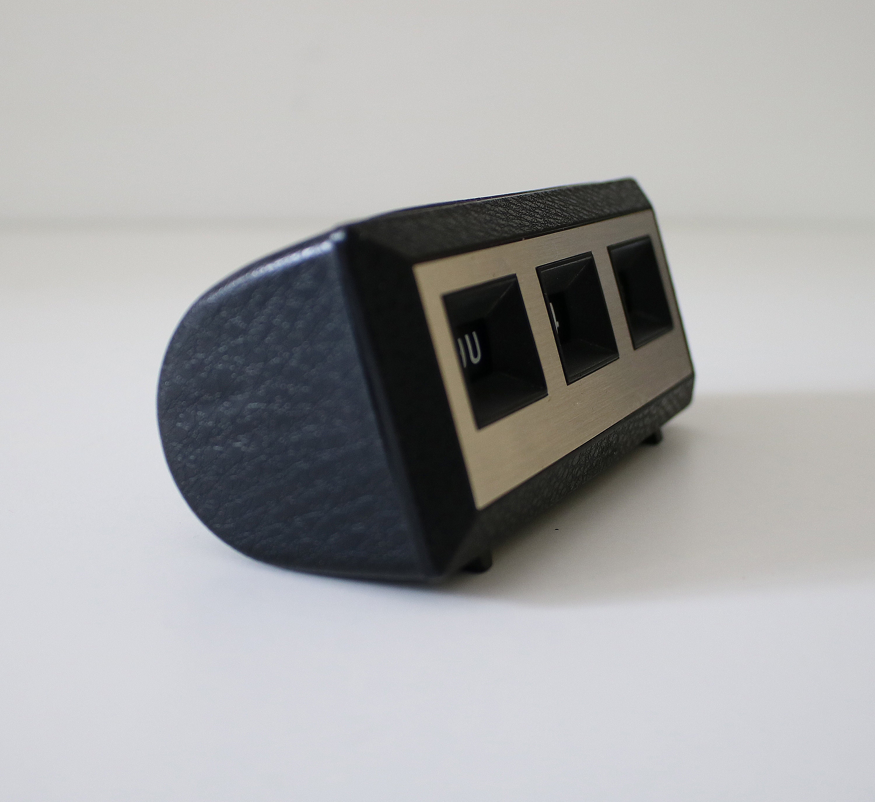 1980s perpetual desk calendar in black textured plastic with silver fascia.