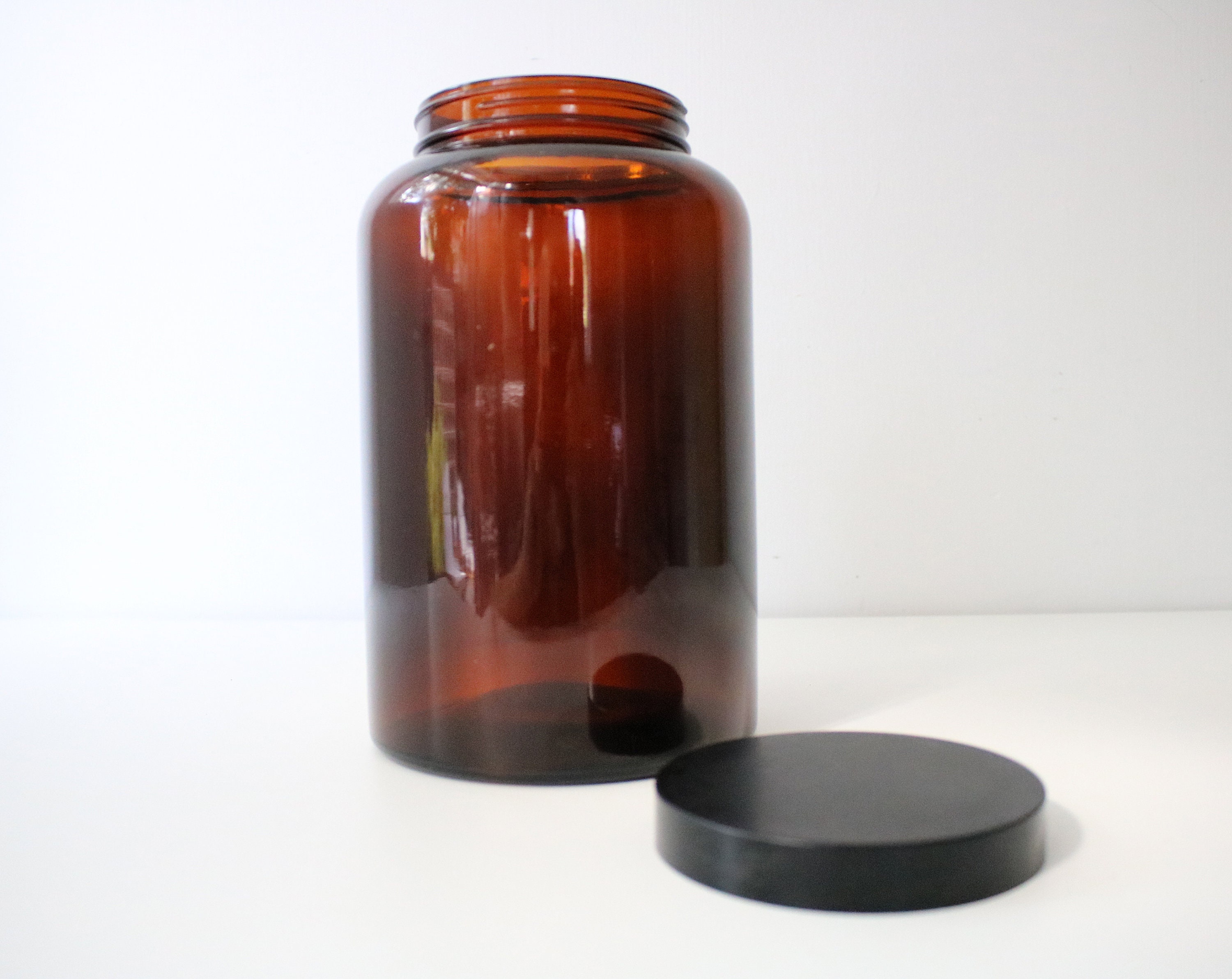 Large 1970s brown / amber glass jar with black screwtop lid Biba