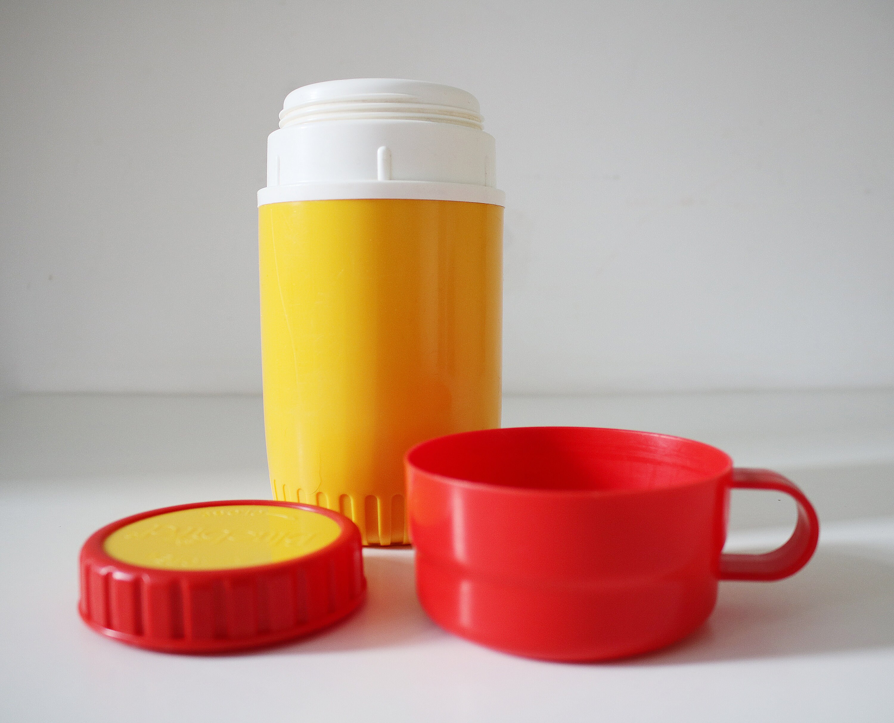1980s flask by Bluebird Toys in bright yellow and red plastic