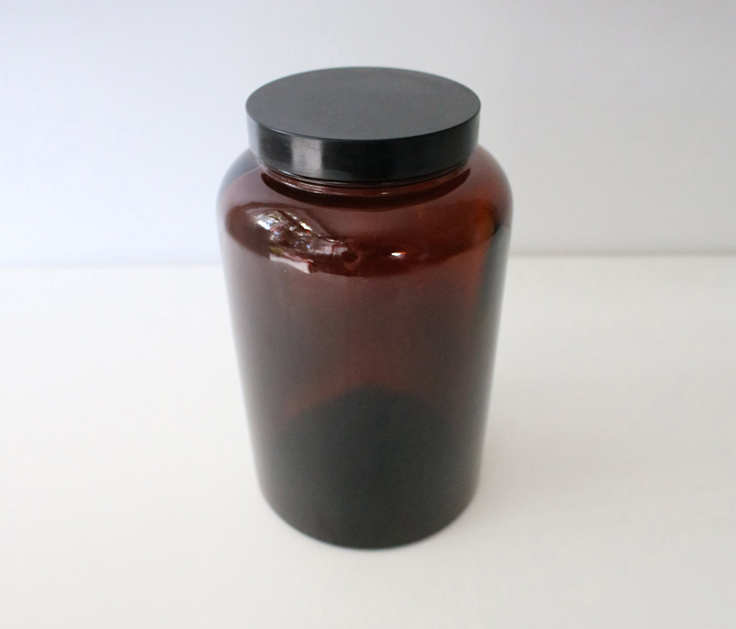 Large 1970s brown / amber glass jar with black screwtop lid Biba
