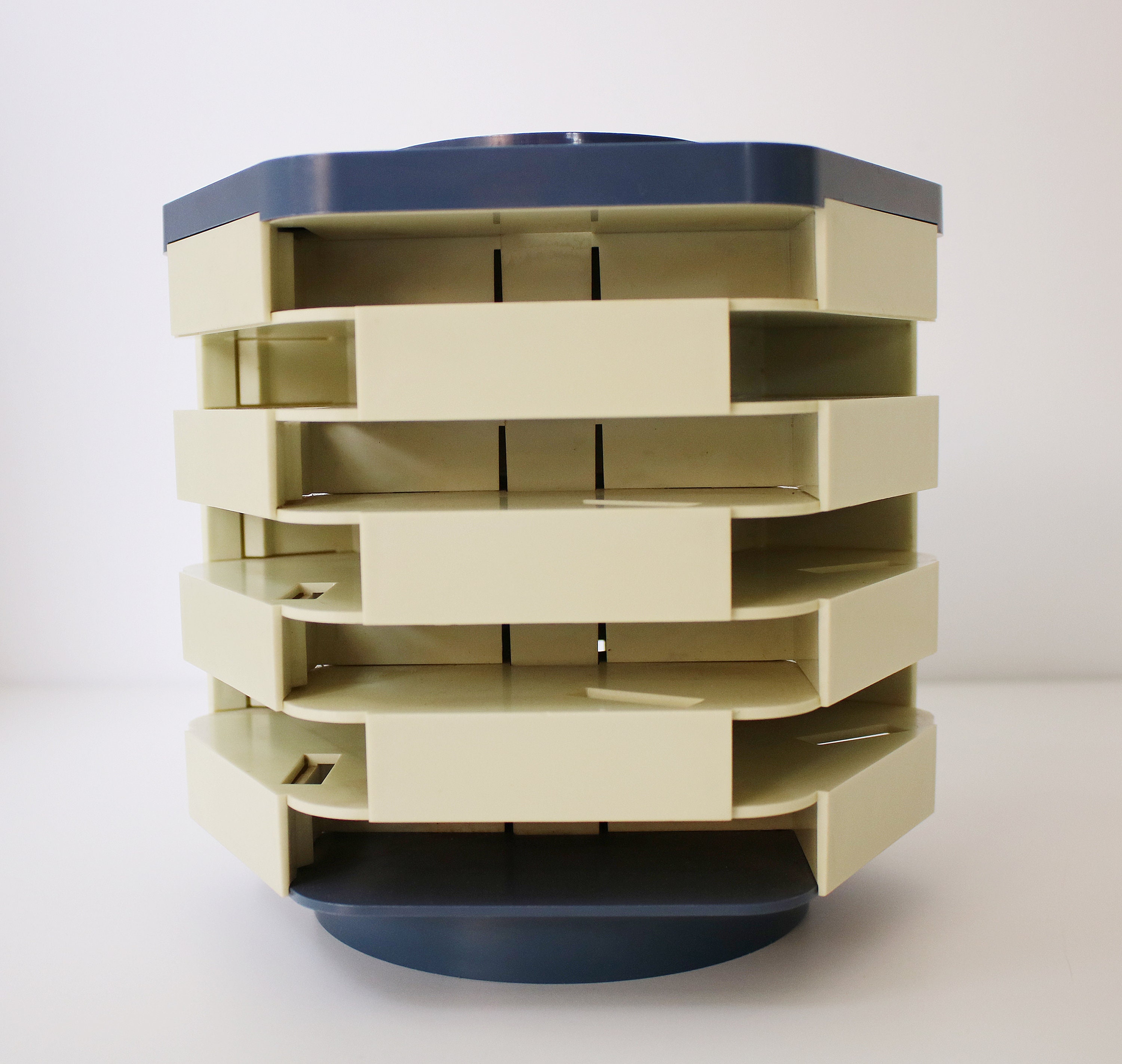 Revolving audio cassette tape storage rack in blue and grey plastic