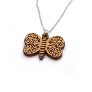 Solid wood butterfly pendant necklace with Celtic knotwork patterns