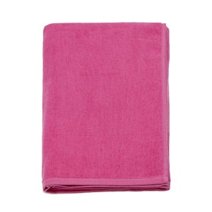 May include: A folded pink bath towel. The towel is made of a soft, absorbent material.