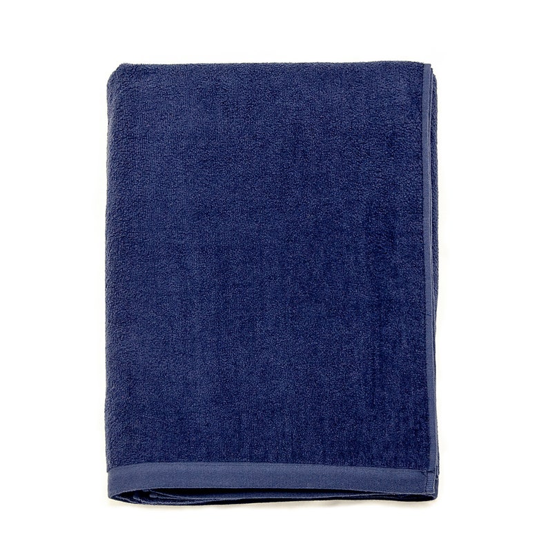 May include: A dark blue bath towel folded in half. The towel is made of a soft, absorbent material.