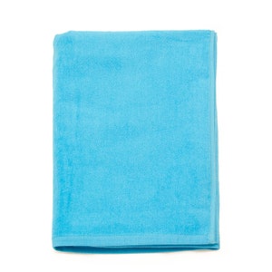 May include: A folded blue towel, made of soft terry cloth, perfect for drying off after a swim or shower.