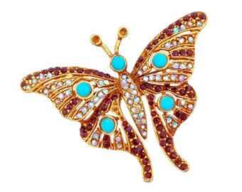 Broche figurative papillon turquoise, aurore boréale et strass rubis, années 1970