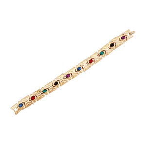 May include: A gold-toned bracelet with a repeating pattern of interlocking links. Each link features a colorful oval-shaped stone, including red, blue, green, and purple.