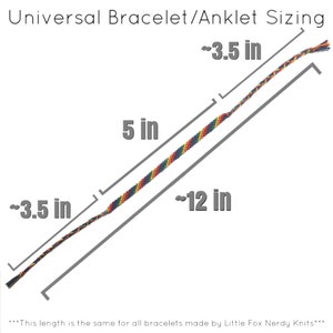 May include: Diagram showing the sizing of a rainbow colored friendship bracelet or anklet. The bracelet is approximately 12 inches long and 0.35 inches wide. The text states that this length is the same for all bracelets made by Little Fox Nerdy Knits.
