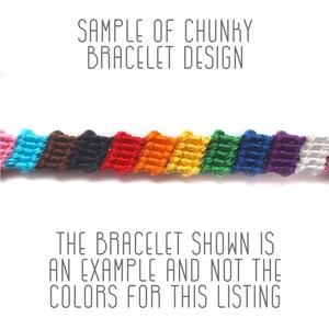 May include: A close-up of a colorful friendship bracelet made with chunky yarn. The bracelet is woven in a rainbow pattern with pink, blue, brown, black, red, orange, yellow, green, blue, purple, and white yarn.
