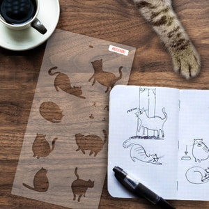 Cat Doodle Bullet Journaling Stencil cleverly adds cute kitties to your bujo layouts. Pick it up over here.